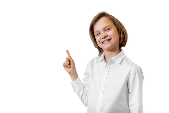 Portrait of cute little happy confident curious schoolboy smiling pointing with hand finger on board isolated on white background. Back to school concept. Smart kid girl learning and development