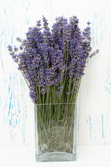 Fresh flowers of lavender bouquet on a white wooden background