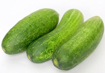 Fresh green and healthy cucumbers on wooden board