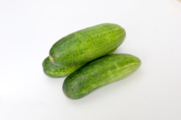 Fresh green and healthy cucumbers on wooden board