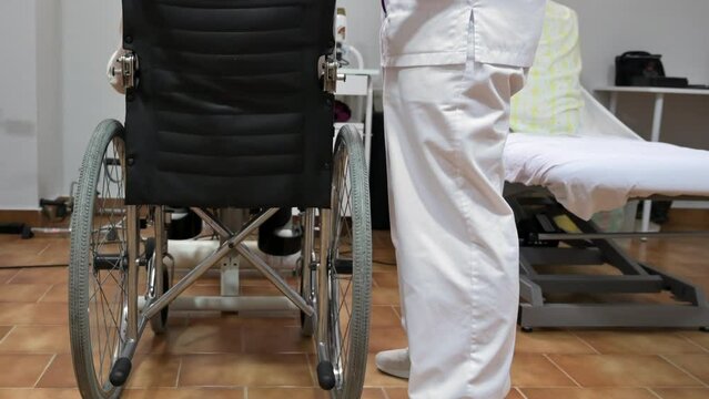 Nurse touch shoulder of elderly patient woman in wheelchair supporting her showing empathy and compassion, caring about old people concept. High quality 4k footage