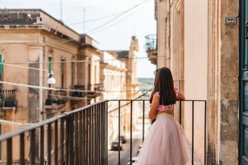 Girl in dress on balcony Italy