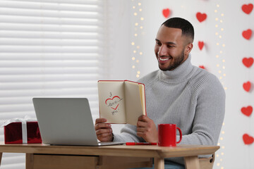Valentine's day celebration in long distance relationship. Man having video chat with his...