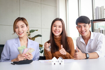 Asian couple buying a house with a real estate agent. Family concept. Moving to a new home or renting property