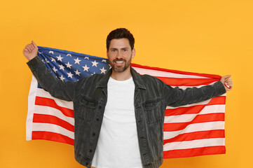 4th of July - Independence Day of USA. Happy man with American flag on yellow background