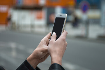 Young girl using smartphone in European city