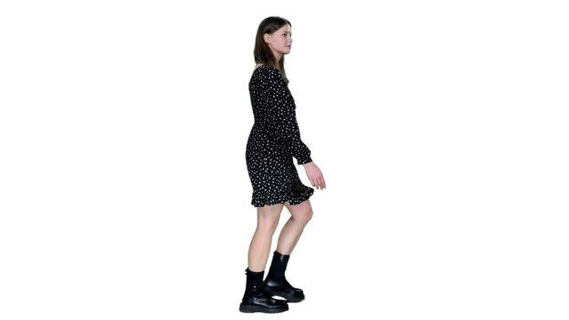 Side view young adult trendy style smiling girl walking in dress and black boots, Full HD footage with alpha transparency channel isolated on white background 