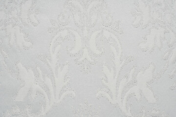 White fabric texture with an abstract pattern.