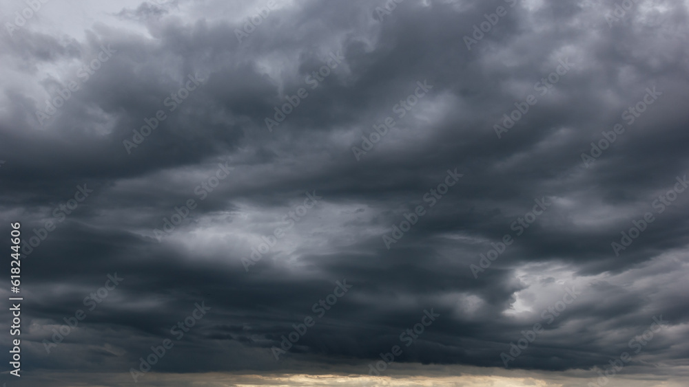 Poster the dark sky with heavy clouds converging and a violent storm before the rain.bad or moody weather s