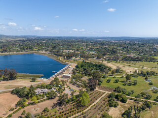 Fototapeta premium Aerial view over water reservoir and a large dam that holds water. Rancho Santa Fe in San Diego, California, USA