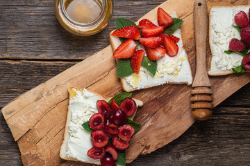 Sandwiches with cream cheese, honey and berries. Dessert
