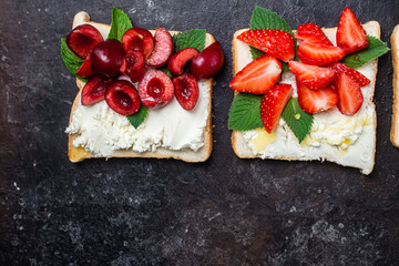 Sandwiches with cream cheese, honey and berries. Dessert
