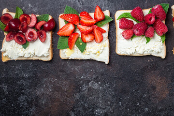 Sandwiches with cream cheese, honey and berries. Dessert