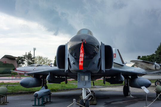 Istanbul, Yesilkoy - Turkey - 04.20.2023: F-4 Phantom Fighter Jet Plane, Supersonic jet Fighter and Bomber. Dark Clouds Background.