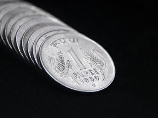 closeup shot of old vintage silver one or 1 rupee coin of india arranged in a straight row isolated...