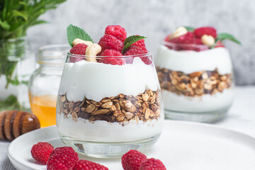 Granola with yogurt and raspberries in a glass