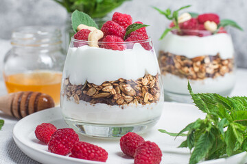 Granola with yogurt and raspberries in a glass