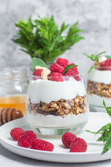 Granola with yogurt and raspberries in a glass