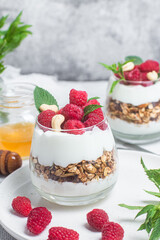 Granola with yogurt and raspberries in a glass