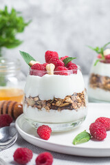 Granola with yogurt and raspberries in a glass