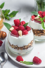 Granola with yogurt and raspberries in a glass