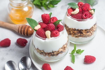 Granola with yogurt and raspberries in a glass