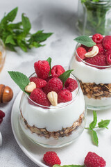 Granola with yogurt and raspberries in a glass
