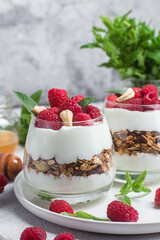 Granola with yogurt and raspberries in a glass