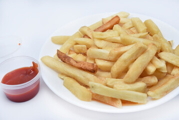 French fries on a white plate and sauce. Delicious breakfast of fried potatoes.