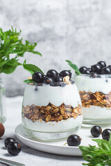 Granola with yogurt and blackcurrant in a glass