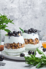 Granola with yogurt and blackcurrant in a glass