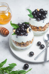 Granola with yogurt and blackcurrant in a glass