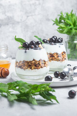 Granola with yogurt and blackcurrant in a glass