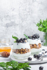Granola with yogurt and blackcurrant in a glass