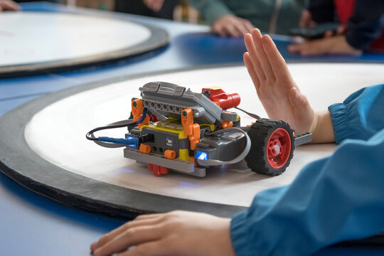 A robot programmed by children is at the starting position. Robotics competitions