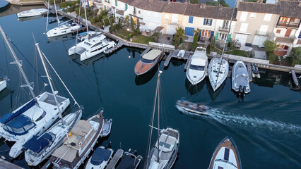 Port Grimaud marina in France in spring with yachts and sailing boats at evening, drone shot, Cote...