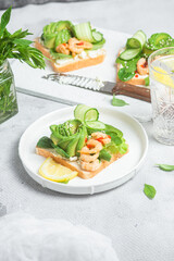 Sandwich with cream cheese, shrimp, avocado and cucumber
