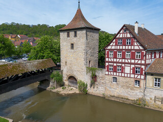 Schwaebisch Hall, half-timbered old town houses with a view of the church tower, drone shot