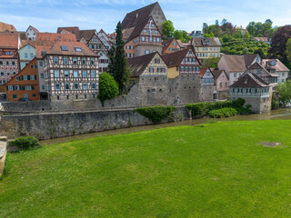 Fototapeta na wymiar Schwaebisch Hall, half-timbered old town houses with a view of the church tower, drone shot