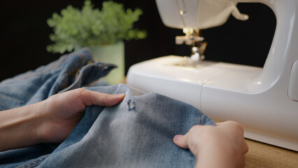 Female stitch jeans at home close up