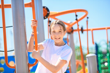 teenager girl on a playground on summer day.