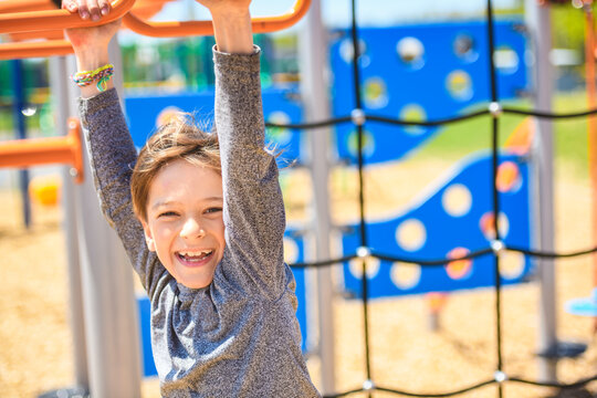child boy on a playground on summer day.