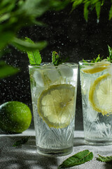 Cocktail with lemon and mint on a dark background. Lemonade