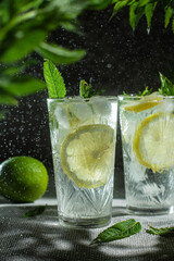 Cocktail with lemon and mint on a dark background. Lemonade