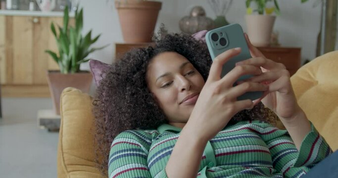 Generation Z Female using Smart phone at Home on Sofa