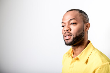 black African Man with yellow clothes on studio white background