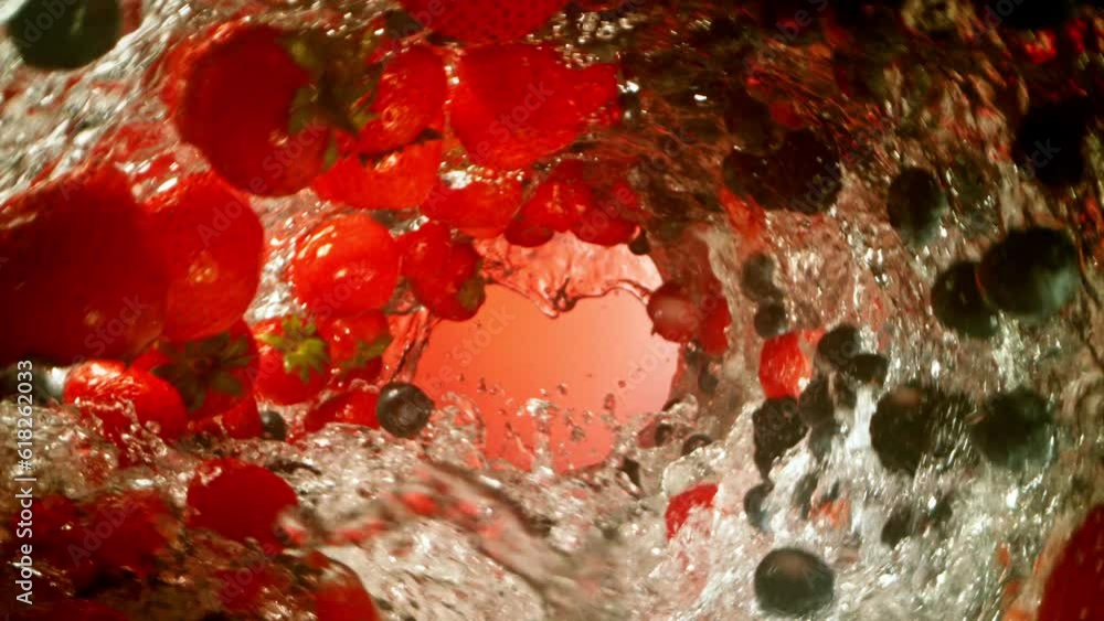 Poster super slow motion of water wave with berries fruit. water surf wave rotating around and creating tun