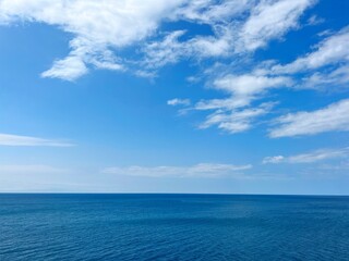 Blue sea blue sky white clouds horizon