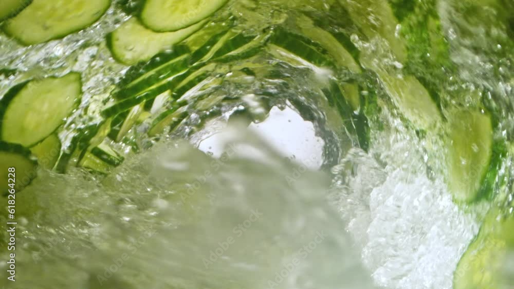 Fototapete super slow motion of water wave with cucumber slices. water surf wave rotating around in creating tu