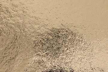 Edible gold leaf sheet as background, closeup